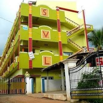 SVL Kranthi College building, Avanigadda — green façade with the prominent S V L lettering